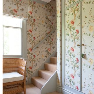 hallway area with floral walls and stairs