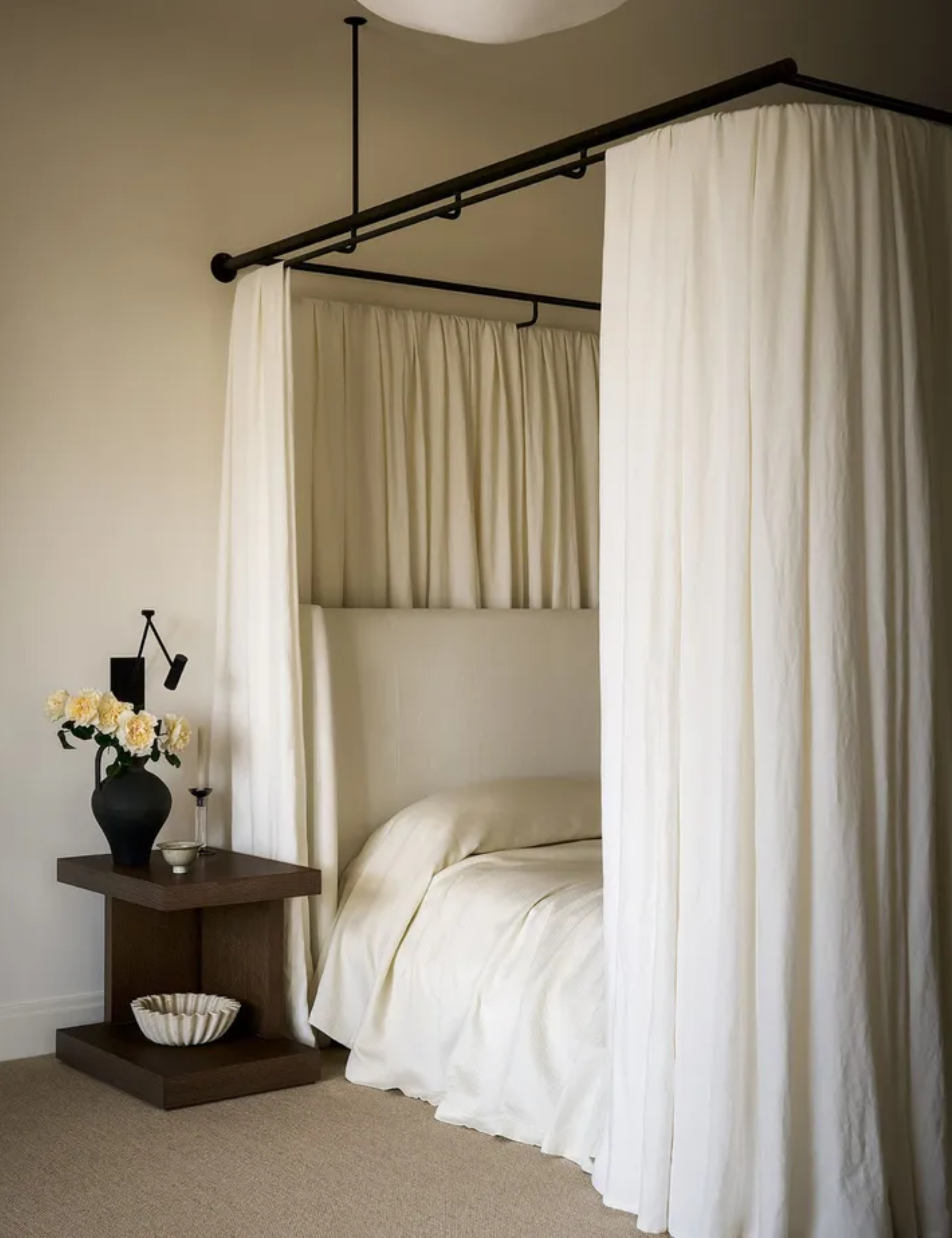neutral minimalist bedroom with canopy bed