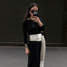 Alexis Badiyi wearing a cummerbund and a black top 