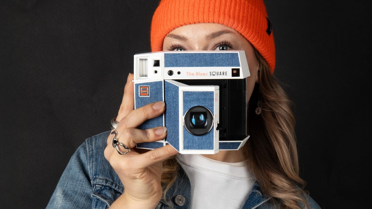 Woman holding Lomo’Instant Square Glass Pemberley edition camera