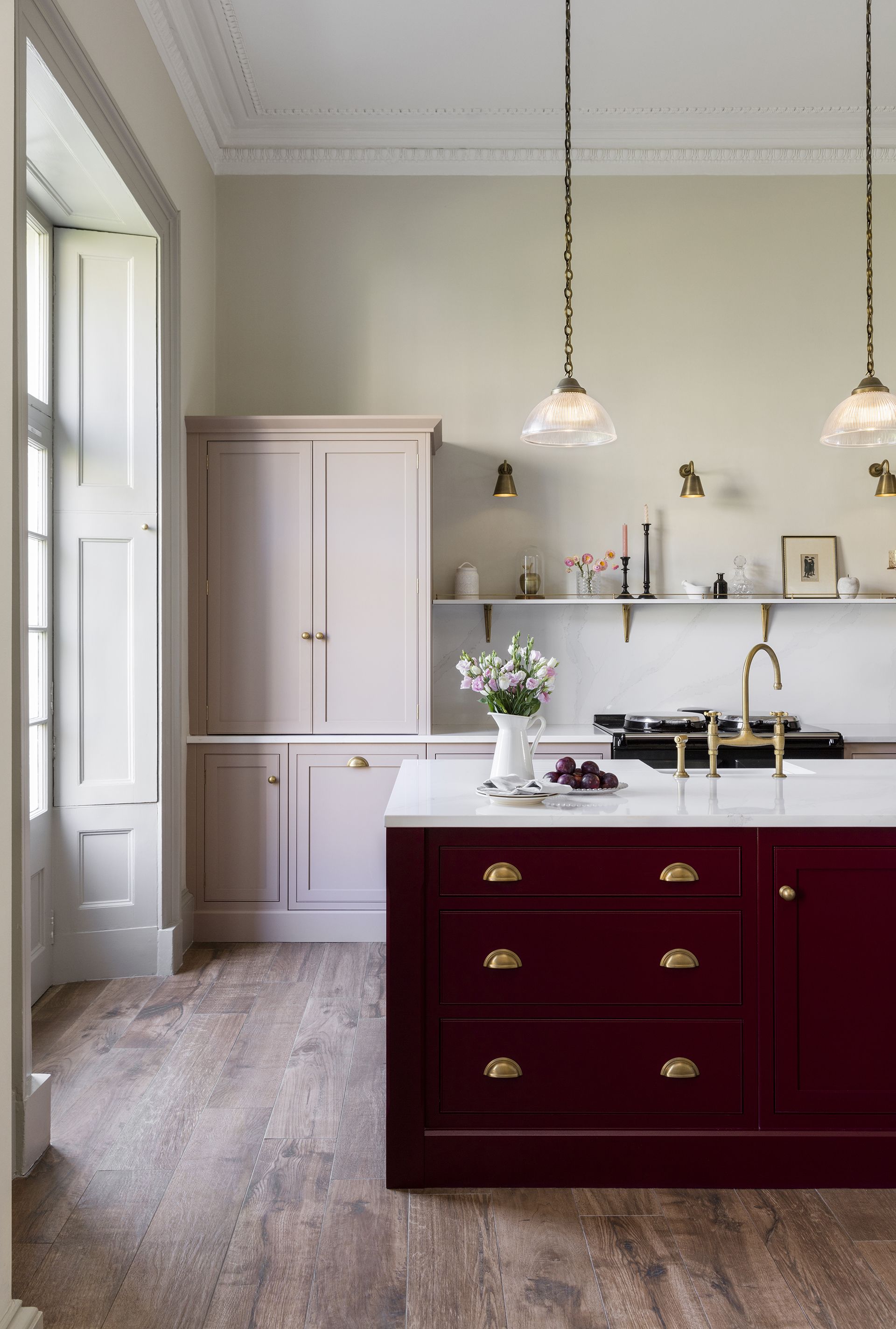 harvey jones kitchen with red island pink cabinetry and wooden floor 2