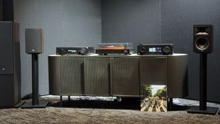 JBL turntable, receiver, and stage 2 speakers playing music with The Beatles' Abbey Road LP in front