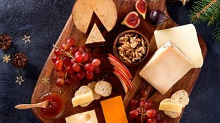 Christmas cheese board with grapes, nuts and figs