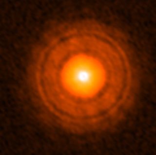 TW Hydrae as seen by ALMA — the dark rings are thought to be locations of planetary formation and the dark outer ring is the possible location of a Uranus or Neptune-like baby exoplanet.