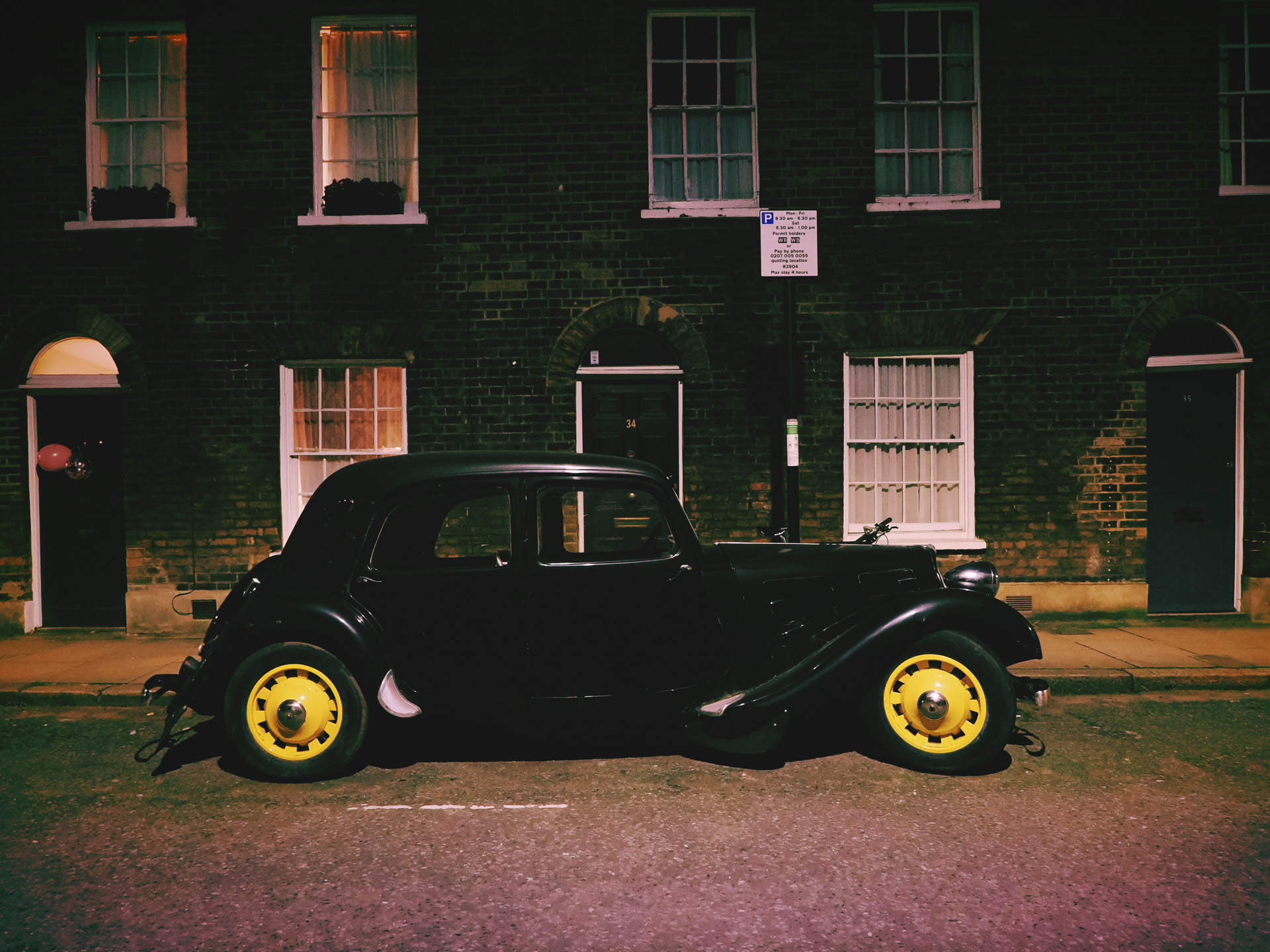 OM System OM-3 sample photos: classic car in quaint London street at night