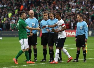 Ashley Cole, right, shakes hands with Republic of Ireland captain Robbie Keane