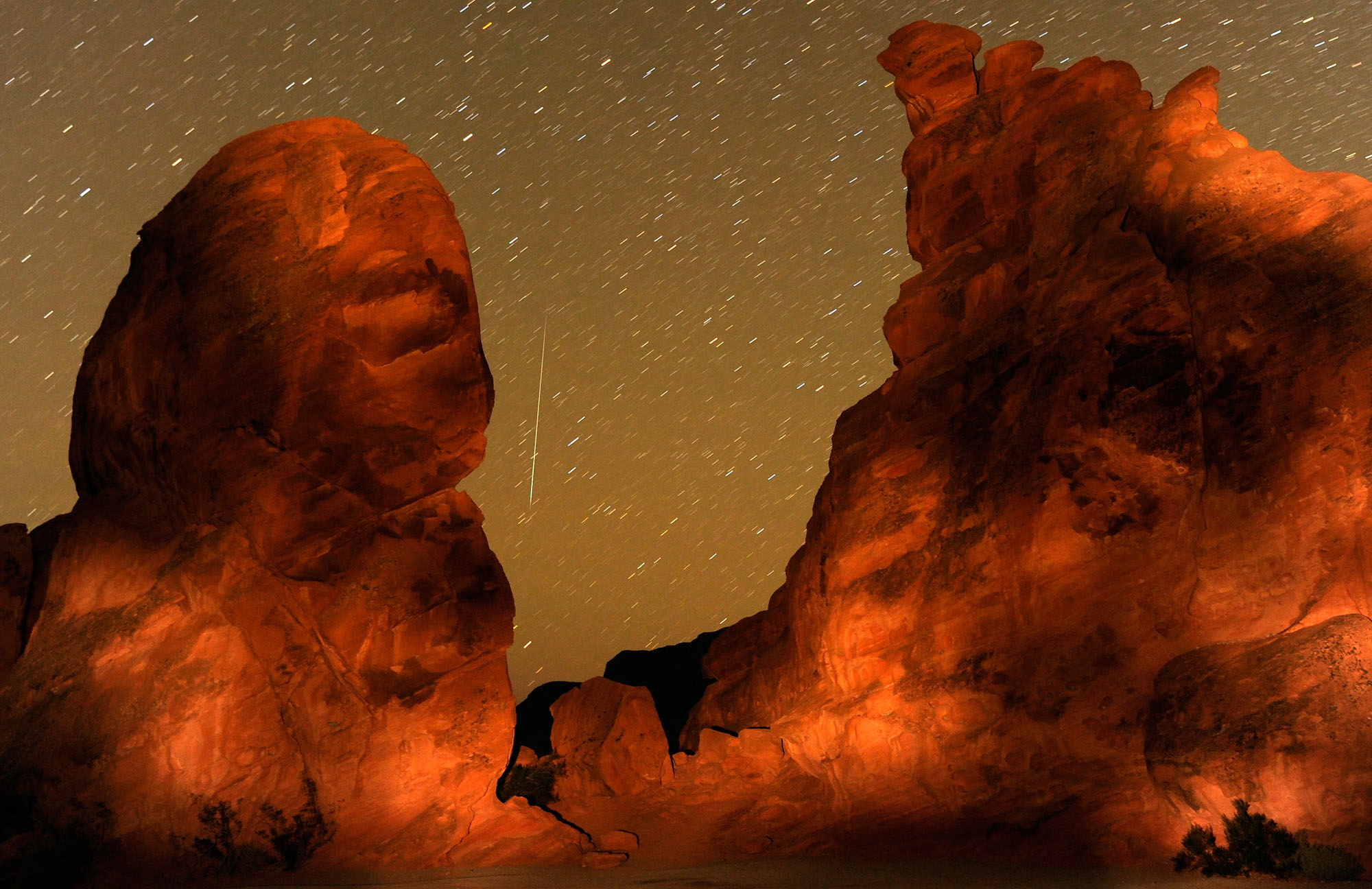 A Geminid meteor streaks between peaks of the Seven Sisters rock formation early December 14, 2010 in the Valley of Fire State Park in Nevada. The meteor display, known as the Geminid meteor shower because it appears to radiate from the constellation Gemi