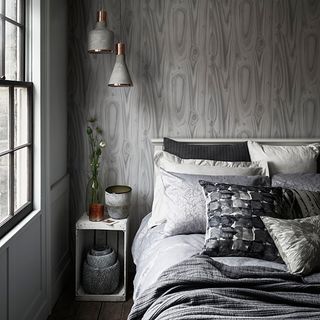 bedroom with grey background and bedside table