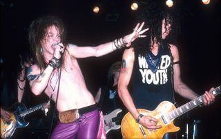 Axl Rose (left) and Slash perform live with Guns N' Roses in 1987
