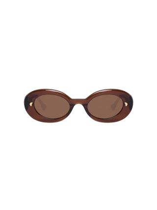 A pair of brown oval sunglasses with golden details.