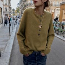 Woman in olive green sweater and jeans