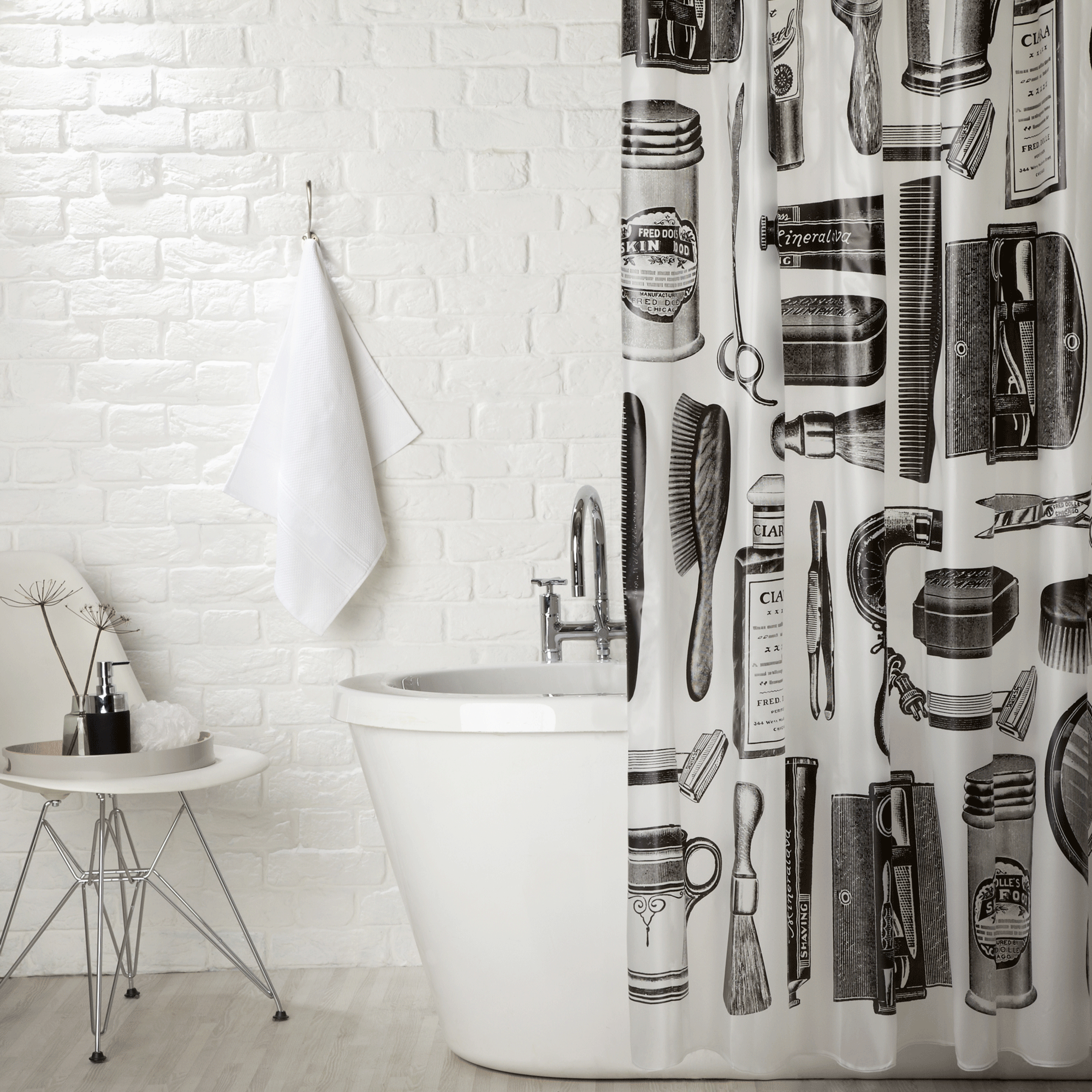 Black and white patterned shower curtain in monochrome bathroom