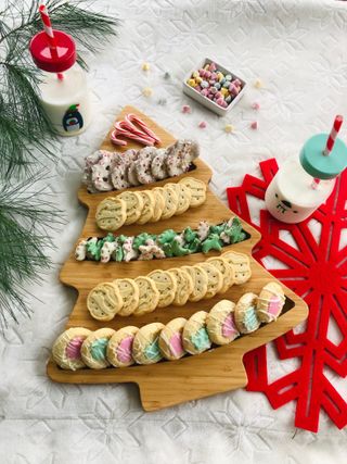 Cookies on a wooden Christmas tree shaped cutting board