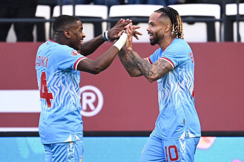 Democratic Republic Of Congo's forward #10 Theo Bongonda celebrates his goal with Democratic Republic Of Congo's midfielder #14 Noah Sadiki during the Africa Cup of Nations (CAN) Group D football match between Democratic Republic of Congo and Benin at Al Medina Stadium in Rabat on December 23, 2025. (Photo by SEBASTIEN BOZON / AFP)