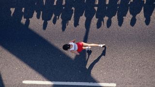 Woman running marathon wearing shorts and vest top