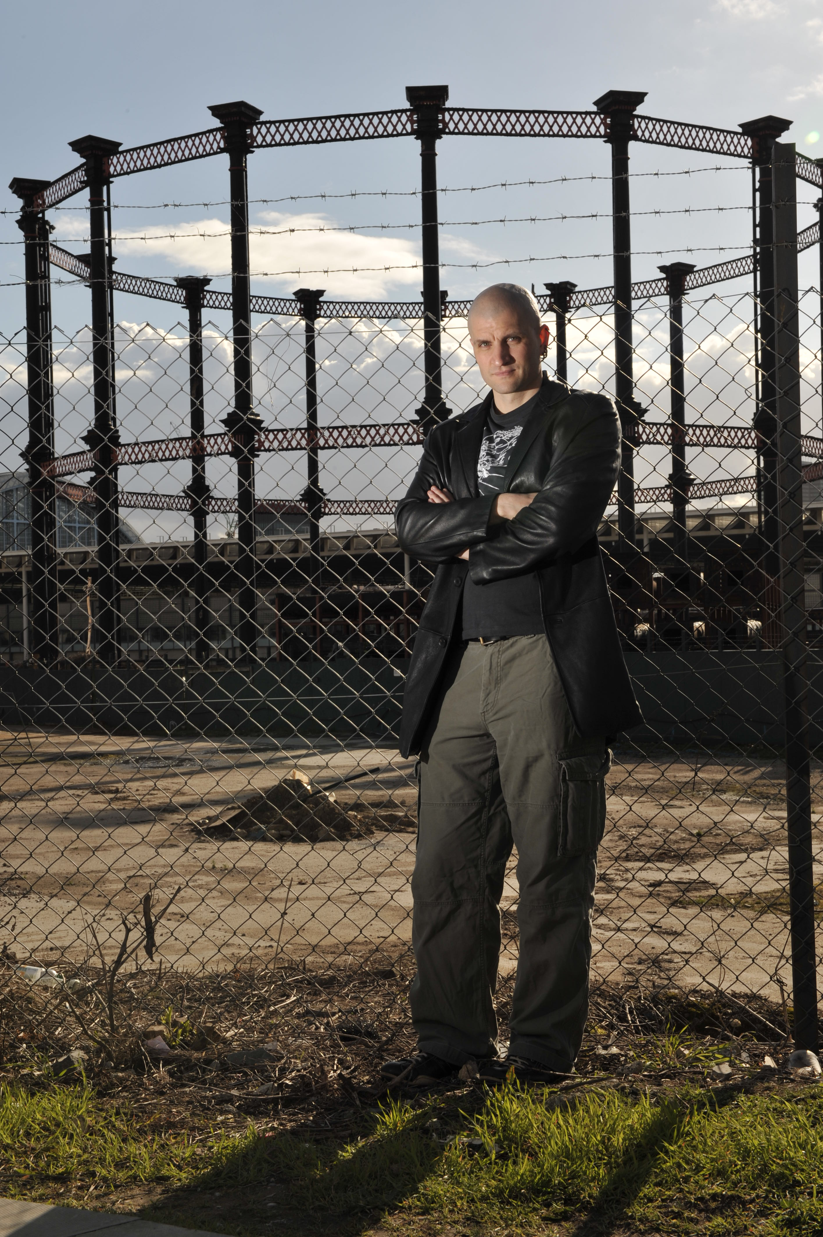 Here we have a grim, urban backdrop with fences and a gas storage holder