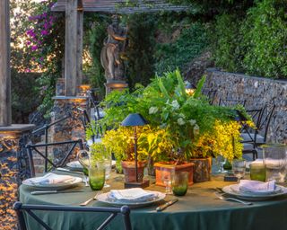 outdoor dining area on a terrace level of a hillside sea facing garden