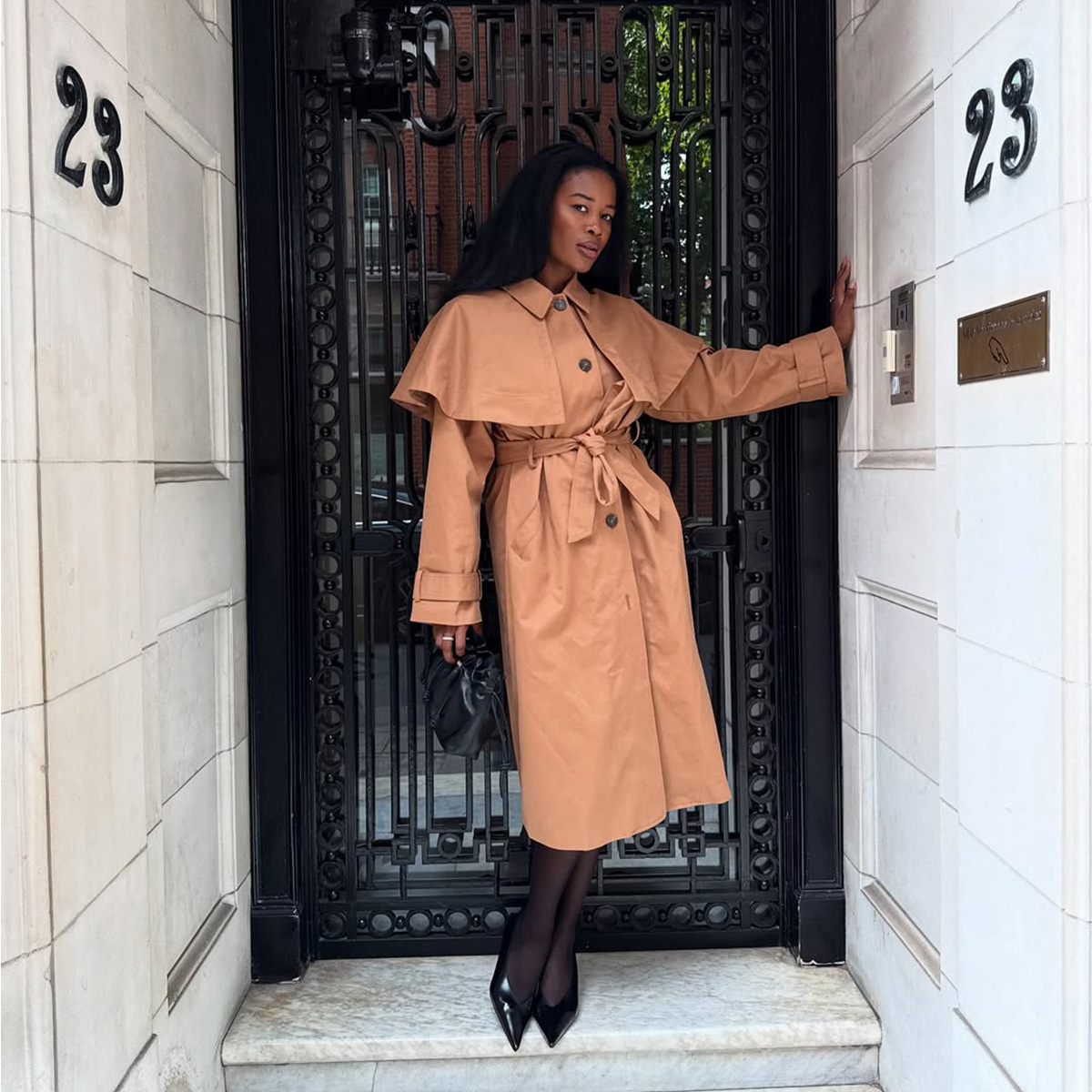 Marilyn NK wearing a trench coat.