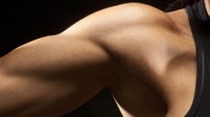 A close up on a woman's bicep as she's flexing slightly 