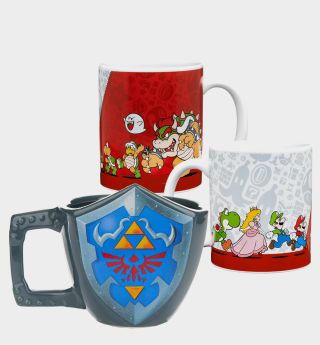 Legend of Zelda shield mug and Super Mario character mugs on a plain background