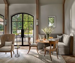 Grey walls and sofa, wooden table and dining chairs