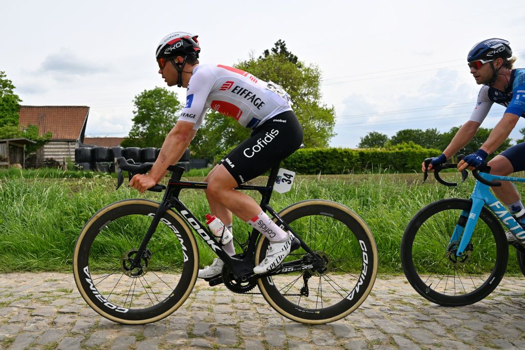 PONTMARCQ FRANCE MAY 17 Milan Fretin of Belgium and Team Cofidis White Best Young Rider Jersey compete passing through a cobblestones sector during the 68th 4 Jours de Dunkerque Grand Prix des Hauts de France 2024 Stage 4 a 1668km stage from Mazingarbe to PontMarcq on May 17 2024 in PontMarcq France Photo by Luc ClaessenGetty Images