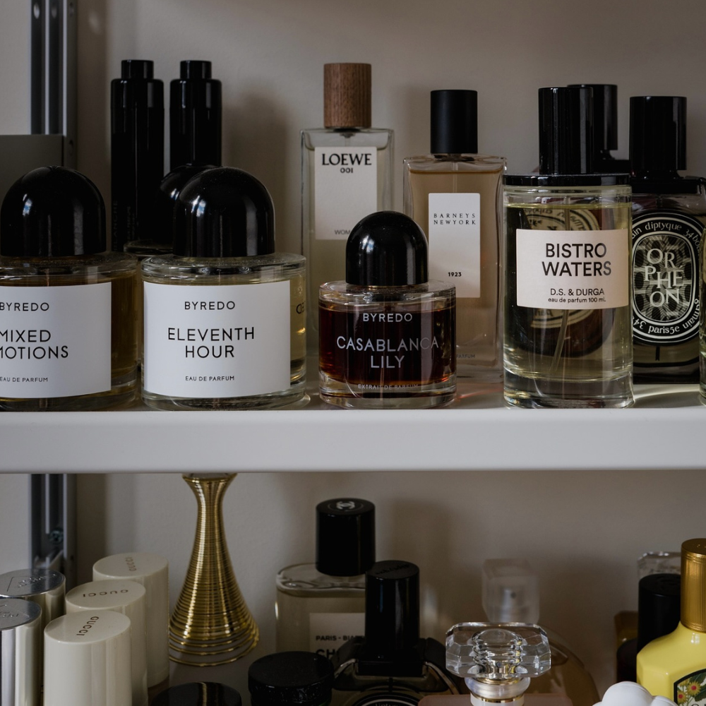 A shelf filled with bottles of perfume