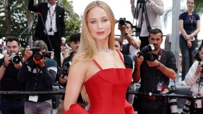 Jennifer Lawrence wears a red gown by Dior at the Cannes Film Festival 