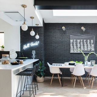 room with bar stools and black brick