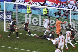 Croatia’s Mislav Orsic, second left, scores against Spain