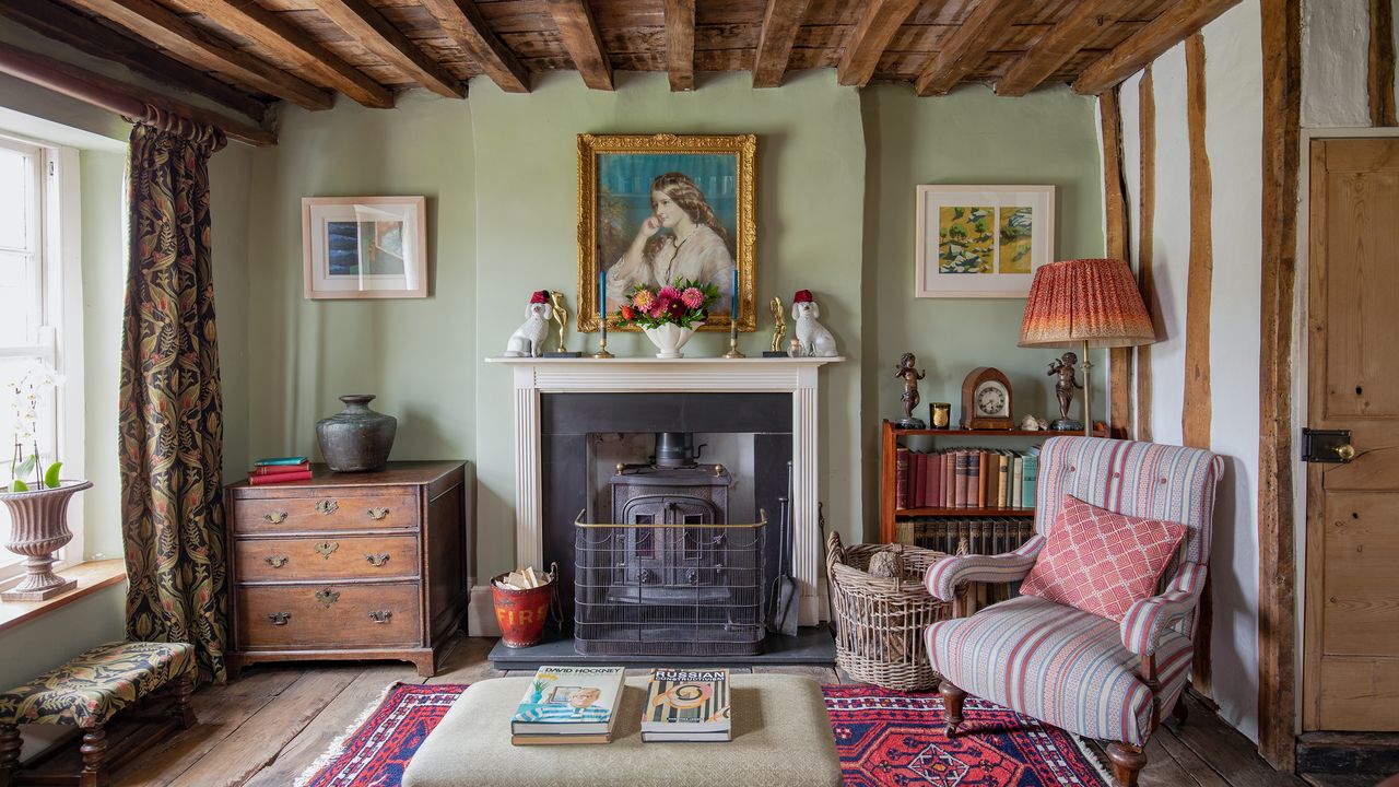 living room in a Tudor house with beamed ceiling, traditional fireplace and chair beside