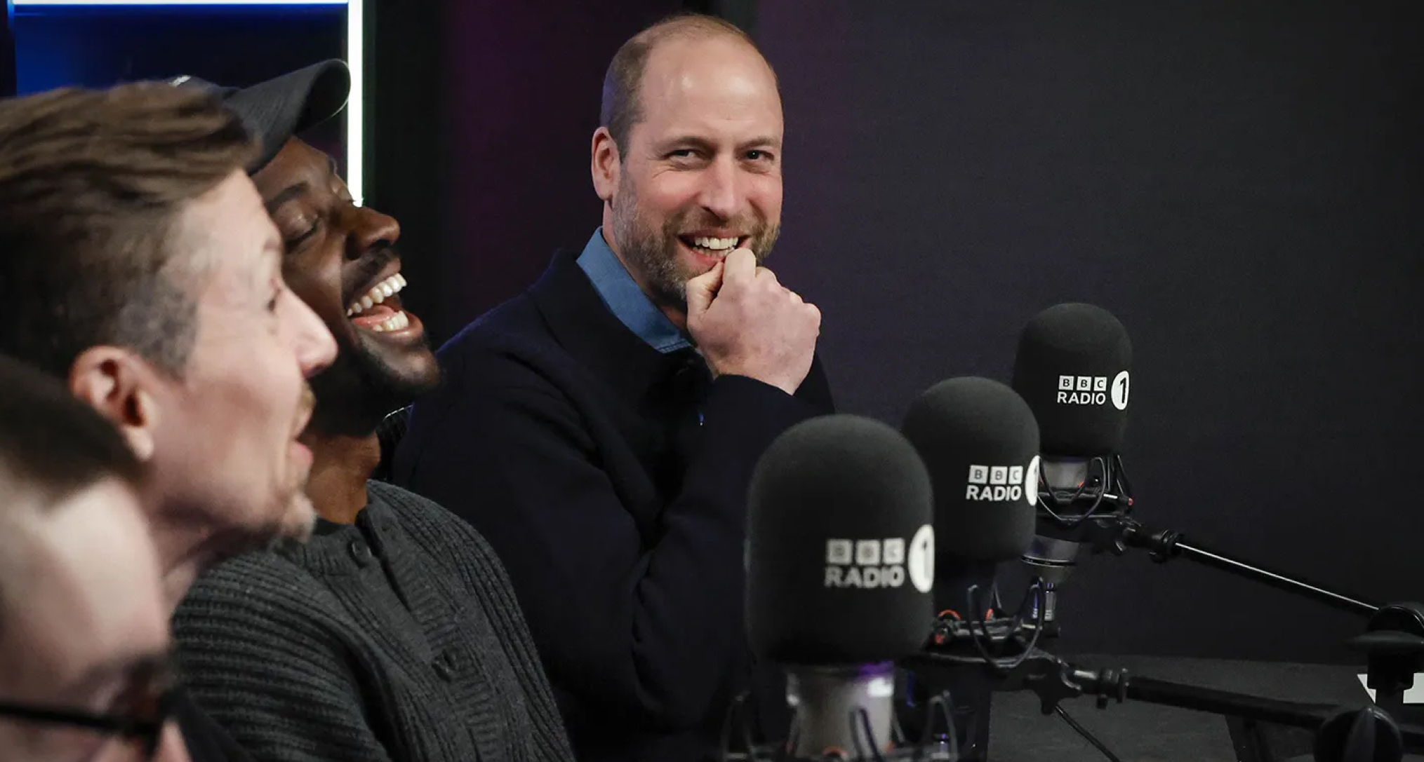 Prince William sitting in front of BBC microphones and smiling