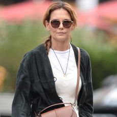 Katie Holmes was spotted in New York wearing a crossbody DeMellier bag and snakeskin boots