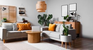 Modern living room with grey sofas and yellow cushions