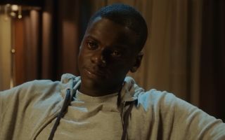 Chris Washington (Daniel Kaluuya) sitting in a chair in Get Out