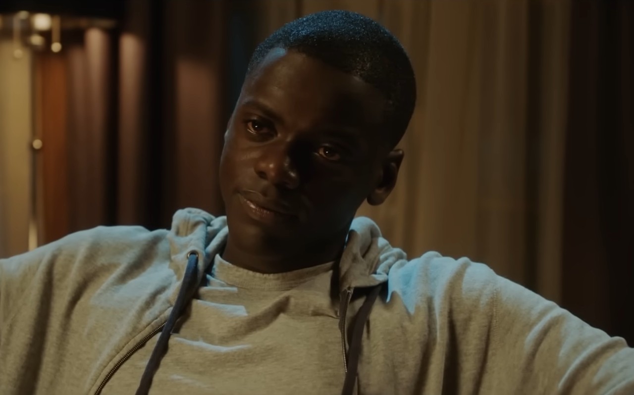 Chris Washington (Daniel Kaluuya) sitting in a chair in Get Out