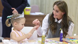 Kate Middleton doing arts and crafts with a young girl