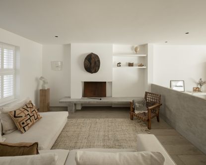 A soft minimalism living room with a cream sofa and large rug