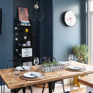 dining area with blue wall and wooden dining table