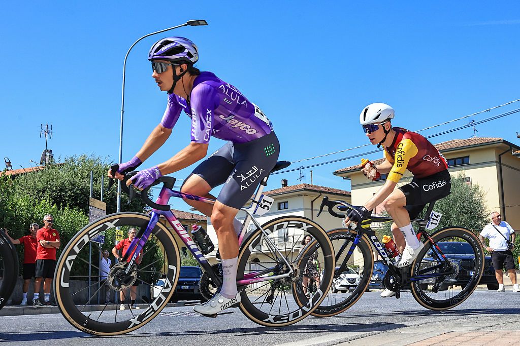 Cyclists celebrating victory in new team colors.