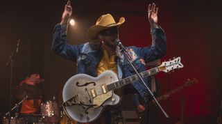 Orville Peck performs onstage with his new Gretsch signature Falcon