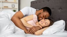 Couple cuddling in bed at home