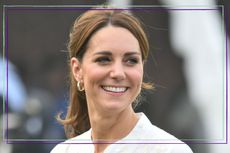 Kate Middleton family photographs - Kate Middleton smiles, while wearing white shirt and her hair up in a ponytail during a visit of the National Cricket Academy on October 17, 2019 in Lahore, Pakistan.