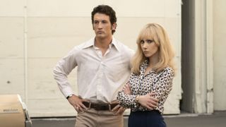 Miles Teller (as producer Albert S. Ruddy) and Juno Temple (as Bettye McCartt) stare in a press photo from The Offer