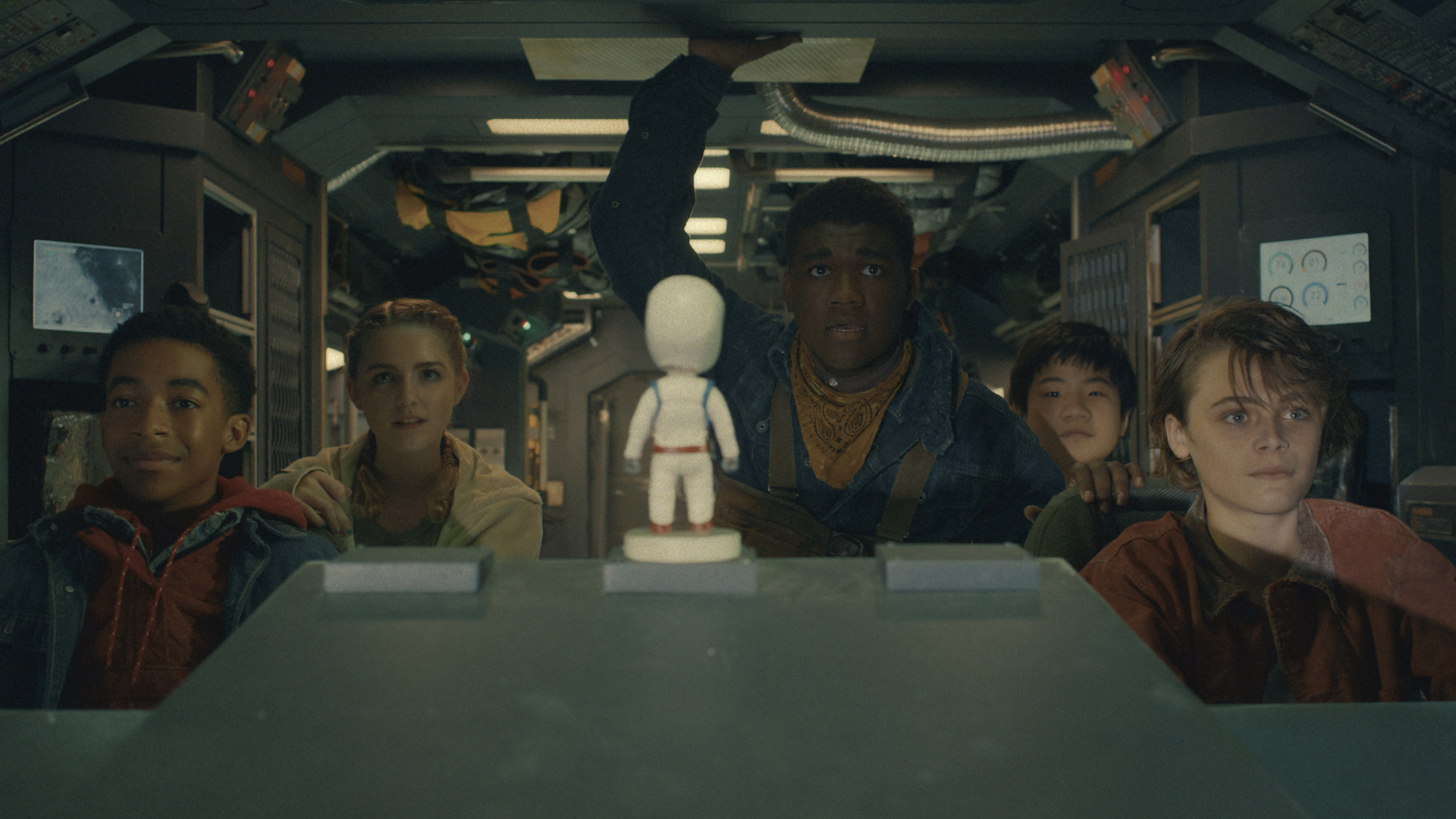 The main cast of the Crater movie driving in a moon mining vehicle