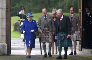 Queen Elizabeth II and Prince Edward, Earl of Wessex walk with Prince Philip, Duke of Edinburgh on August 07, 2012 in Aberdeenshire