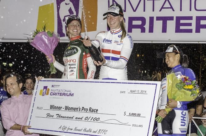 Hannah Barnes (UnitedHealthcare Pro Cycling) sprays the crowd with champagne following her win in Charlotte. Erica Allar (Colavita-Fine Cooking) in second and Barnes' teammate Coryn Rivera look on from either side.