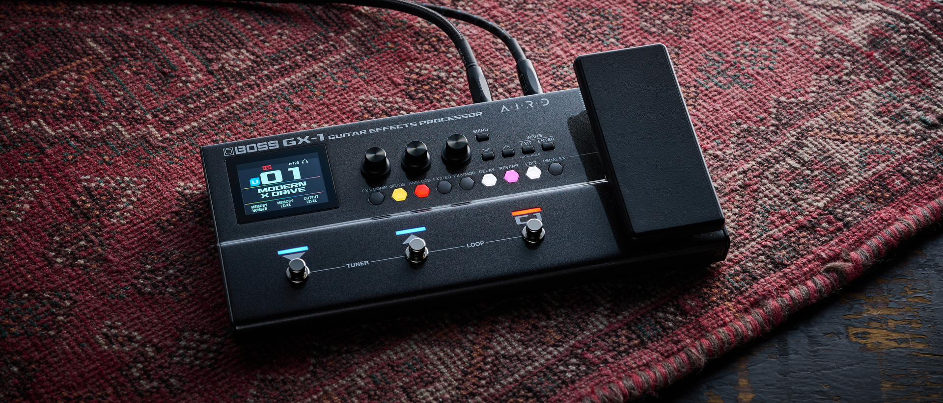 A Boss GX-1 multi-effects pedal on an old, worn rug