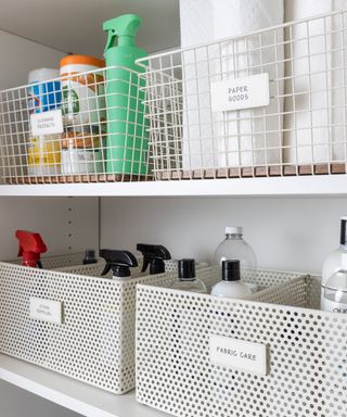 White shelves with white labeled boxes filled with toiletries