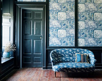 Blue small sofa with swallows, blue patterned wallpaper by Mulberry Home